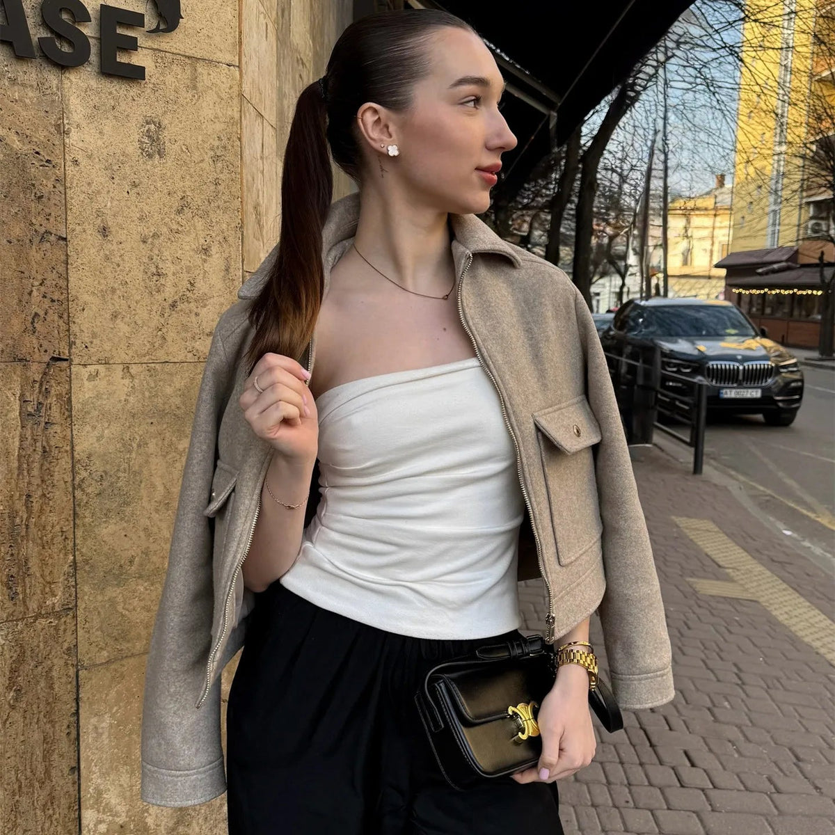 Oatmeal zip jacket worn off the shoulders