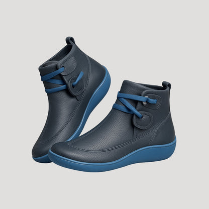 Pair of blue ankle boots with contrast wrapped strap and sole
